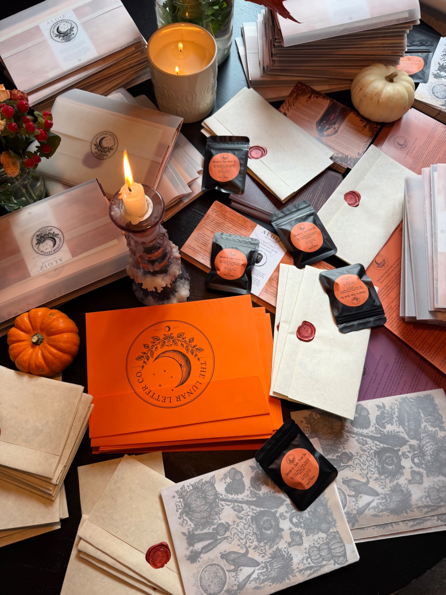 October Lunar Letters with candles, pumpkins, sealed envelopes and seasonal tea